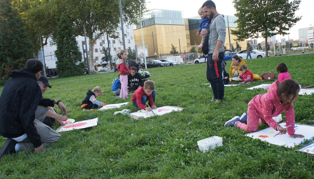 Un "mercredi léger" sur l'esplanade Mandela le 6 septembre. Des enfants albanais et français dessinent avec leurs parents et des membres du collectif Agir Migrants. ©LB/Rue89Lyon