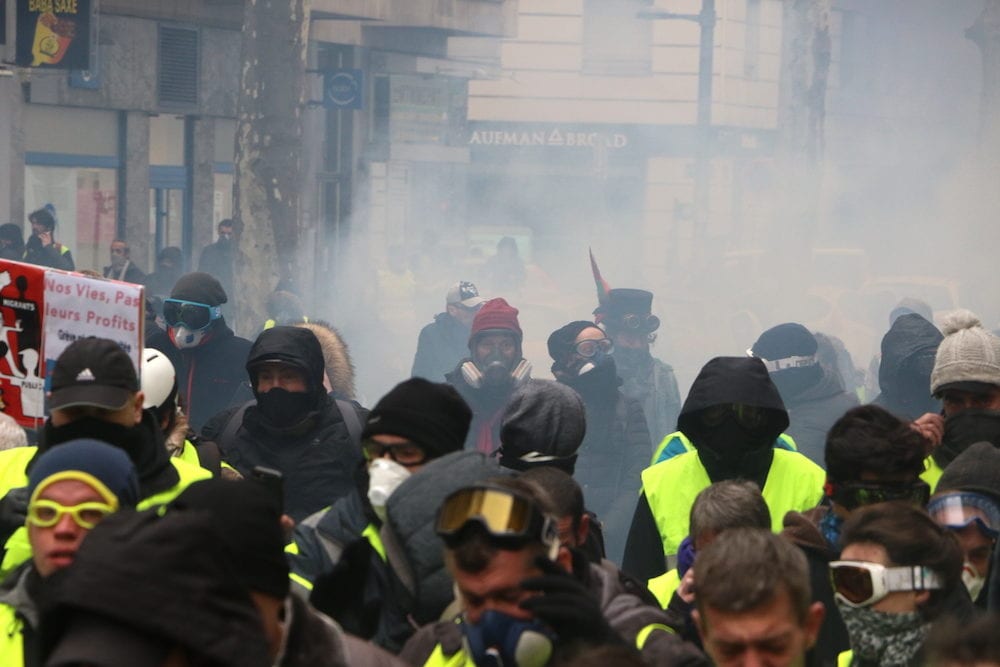 Les manifestants se protègent des lacrymogènes lors de l'Acte XI des "Gilets Jaunes" samedi 26 janvier 2019. ©MG/Rue89Lyon